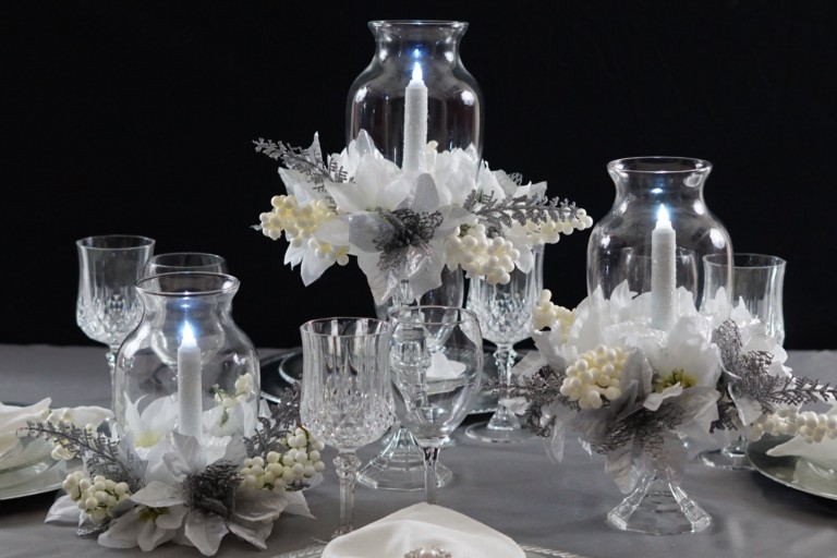 Festive Christmas centerpieces arrangement with candles, ornaments, and greenery